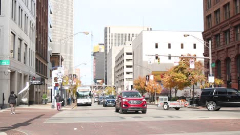 busy traffic in downtown city with moving cars in autumn fall - intersection on high street columbus ohio