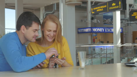 Happy-Adult-Couple-With-Smart-Phones