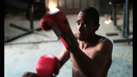 african american male boxer practicing boxing with trainer in fitness studio 4k