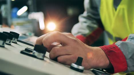 close up of a machinery console getting operated by an engineer