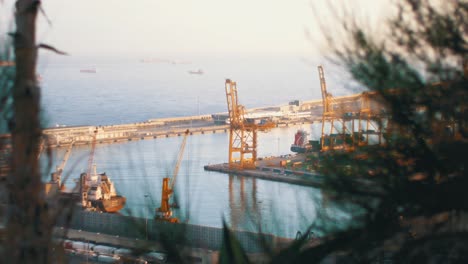 yellow cargo loading crane at international shipping port of barcelona in bay