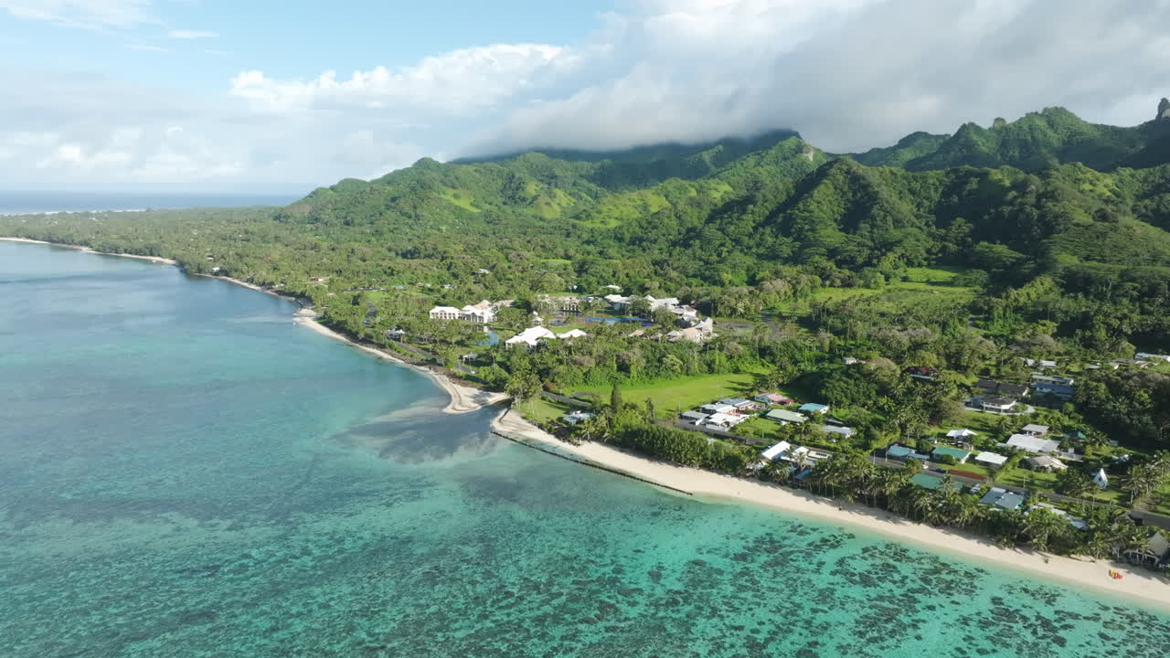 Aerial angled approach establishing of abandoned hotel in Rarotonga Cook Islands, sunny day