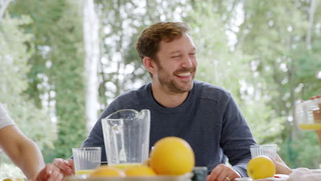 family wearing pyjamas sitting around table enjoying pancake breakfast together