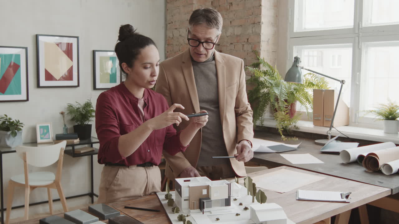 Architects Taking Photo Of 3D Layout Of New Modern House