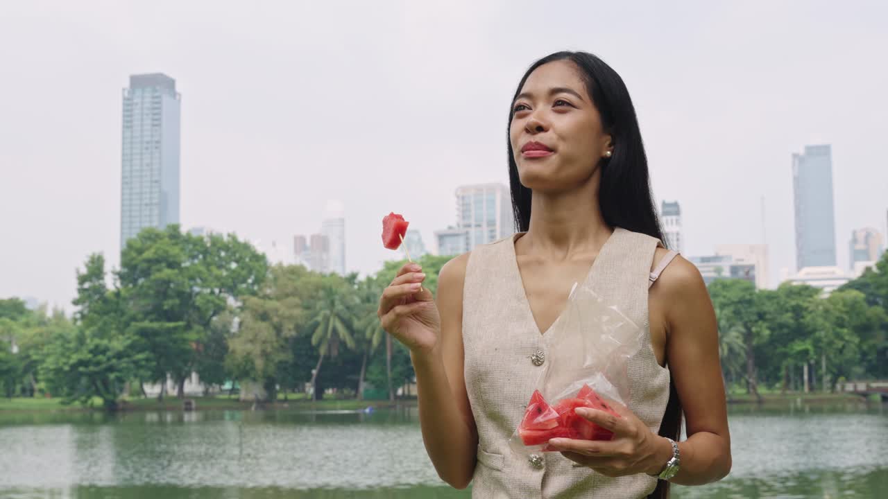 Woman eating watermelon in the park