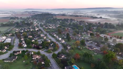 fog covered american neighborhood in rural usa during sunrise