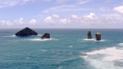 Jagged-eroded-rock-pillars-in-foamy-waves-of-Atlantic-ocean,-Azores