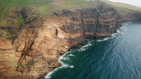 Ocean washing island cliffs drone view. Amazing travel destination in summer