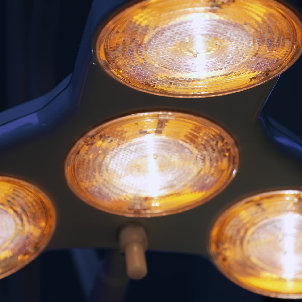 Lamp switched on in the surgical room. Dim light in the surgical theatre at backdrop. Low angle view