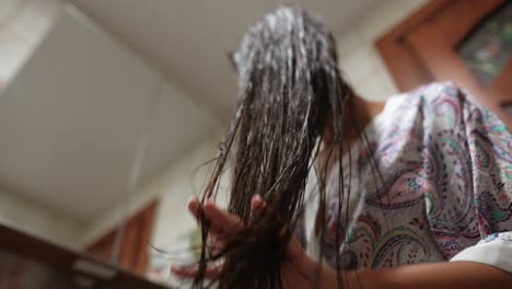 woman washing her long hair in a bathroom