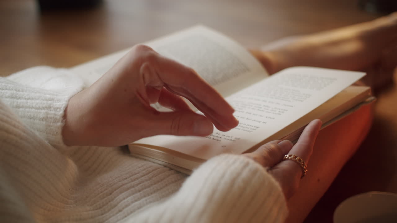 closeup of a young woman reading a book, cozy