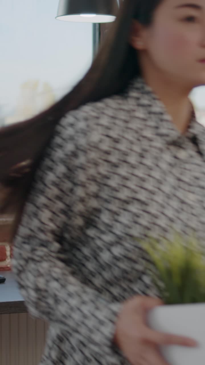 A woman in an office near a window