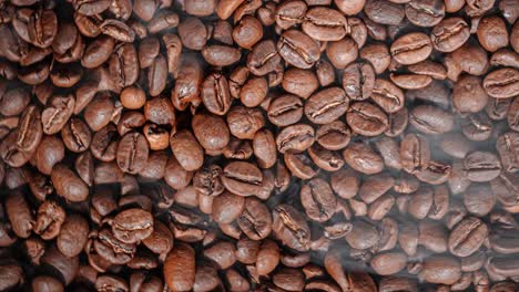 close up of seeds of coffee. fragrant coffee beans are roasted smoke comes from coffee beans.