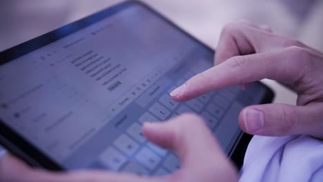 close shot in 4k slow motion of person typing on a ipad keyboard