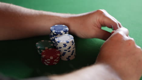 Ein-Mann,-Der-Auf-Seine-Karten-Schaut-Und-Seine-Pokerchips-Bewacht