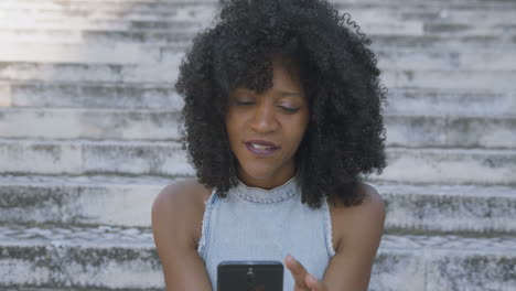 pretty woman texting on phone, turning head to camera, smiling