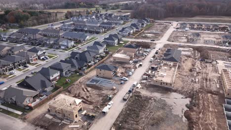 drone flyover of finished suburb next to construction of new homes in various states of completion