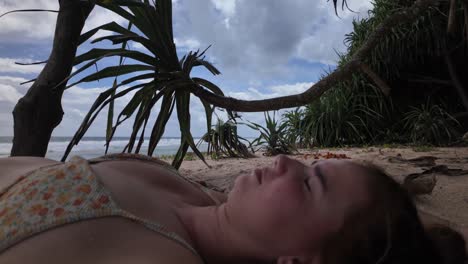 young woman relaxing at the beach under palm tree shade sri lanka holiday