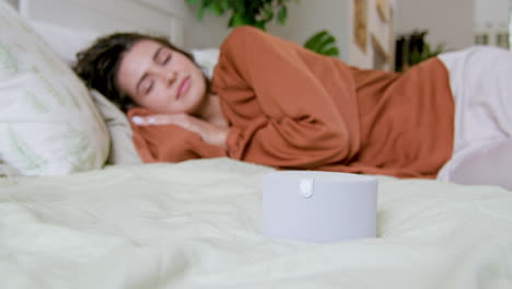 Close-up-view-of-smart-speaker-on-the-bed