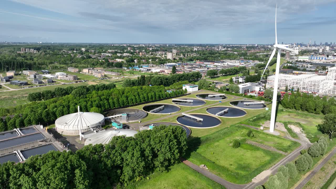 Waste water treatment plant in the port of Rotterdam, along the Meuse river. Cleanign water. Utility in industrial port area. The Netherlands. Aerial view.