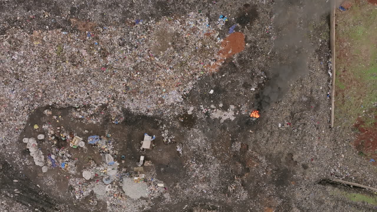 Close top down aerial footage that is descending of a fire in a landfill