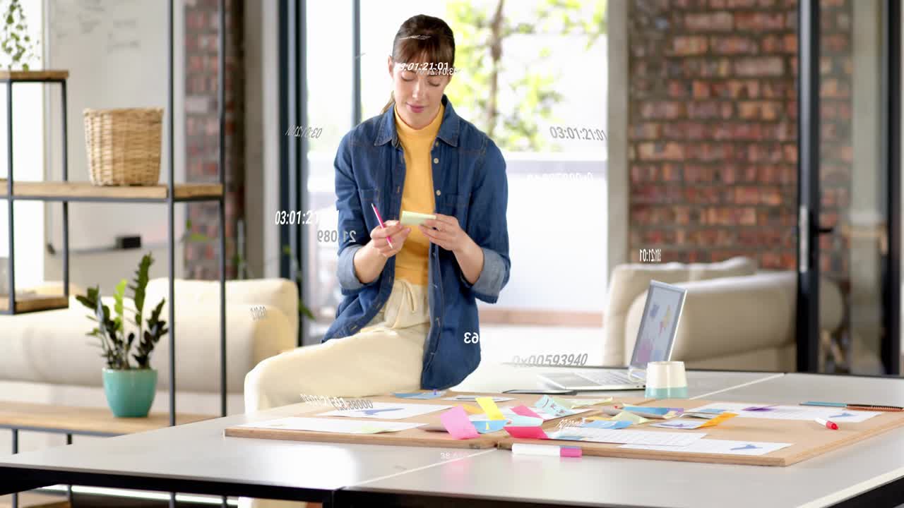 Woman picking pen, writing and moving sticky notes for design plan, timestamps appearing over notes