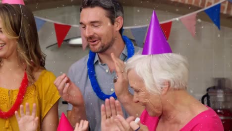 animation of white spots over family having fun at birthday party