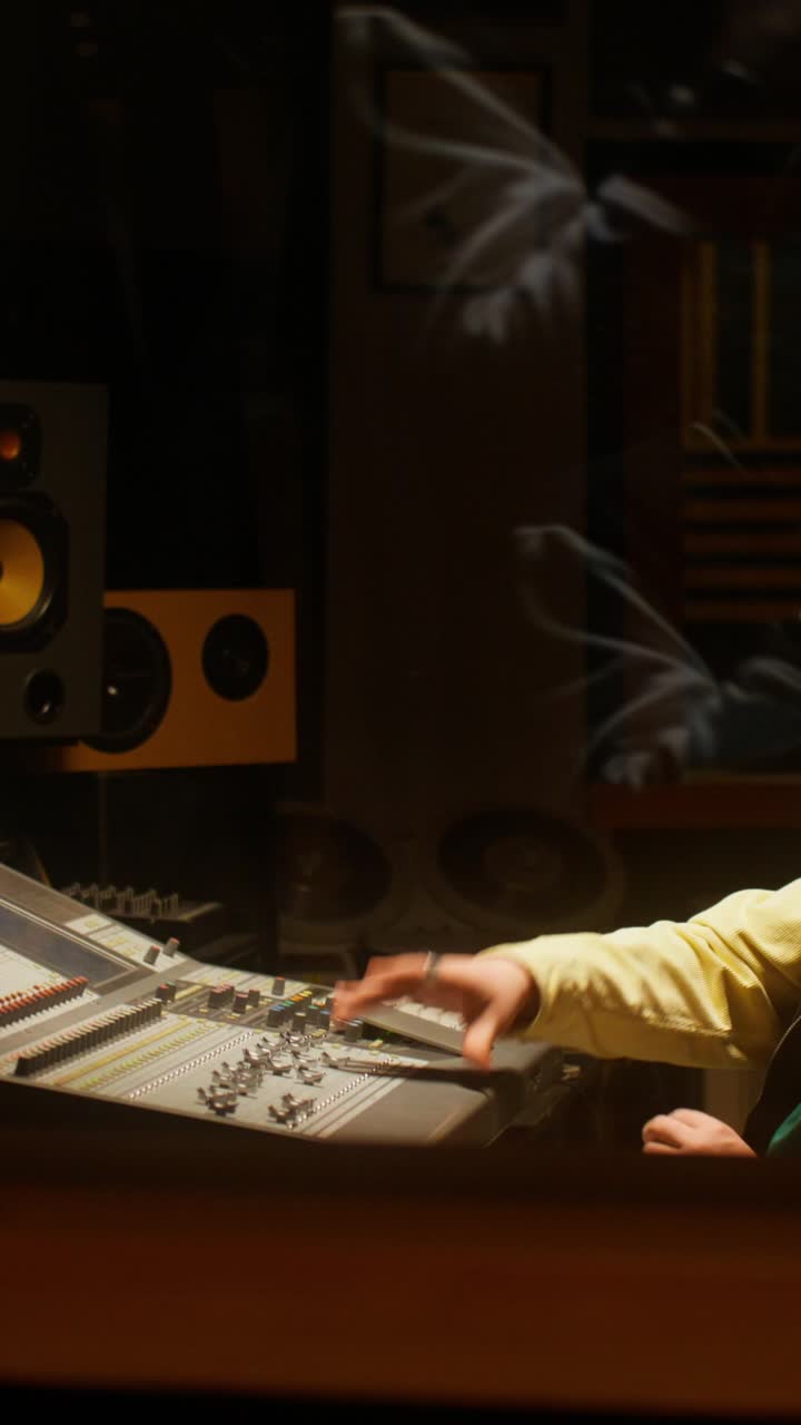 Sound engineer working on a mixing console in a recording studio