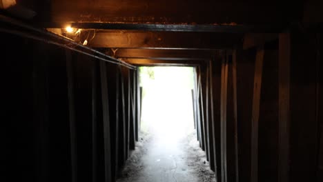 dark tunnel with 'watch your head' sign