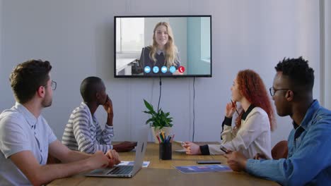 Creative-business-colleagues-in-video-conference-in-meeting-room-in-modern-office