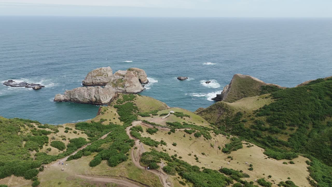 Aerial view of the stunning Muelle De Las Almas in Chonchi, Chile, showcasing the dramatic coastline and the vastness of the Pacific Ocean. push forward