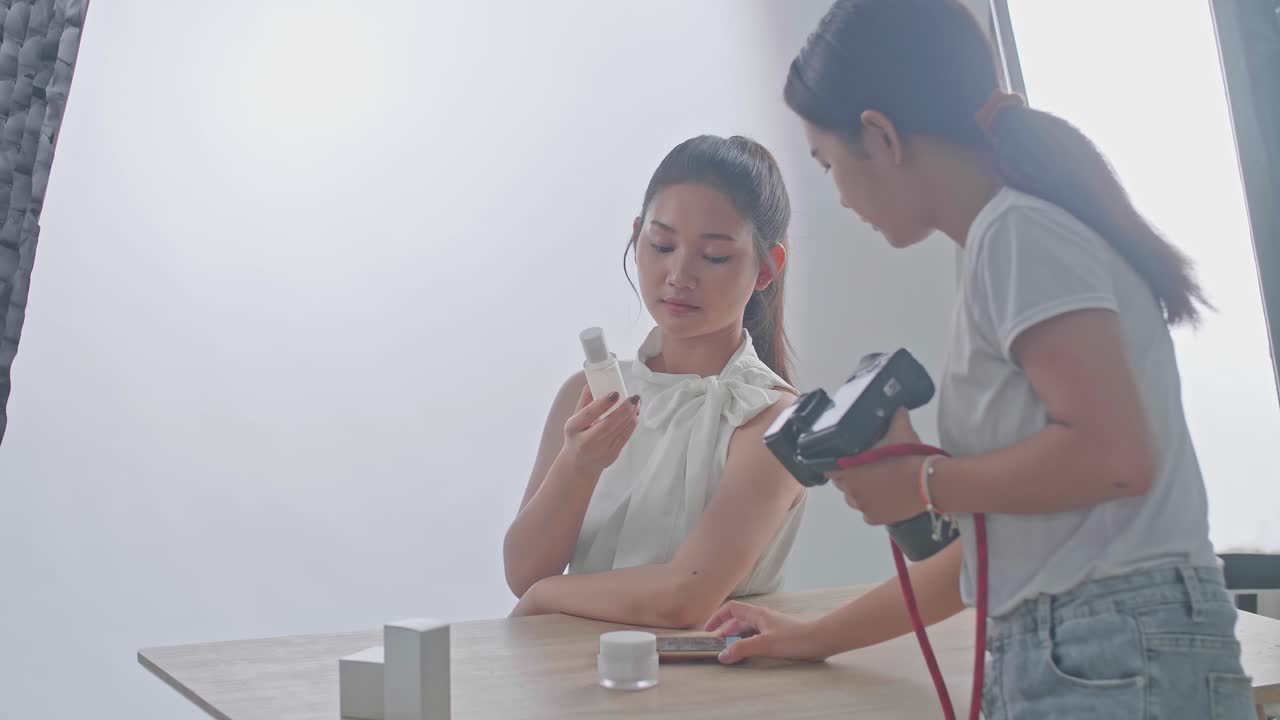 Young Asian Female Photographer Explain How To Pose To The Asian Model In Studio