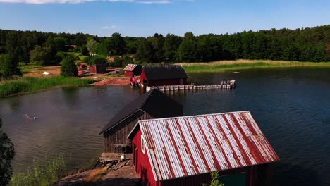 aerial view over boatsheds on the coast of aland, sunny summer day in finland