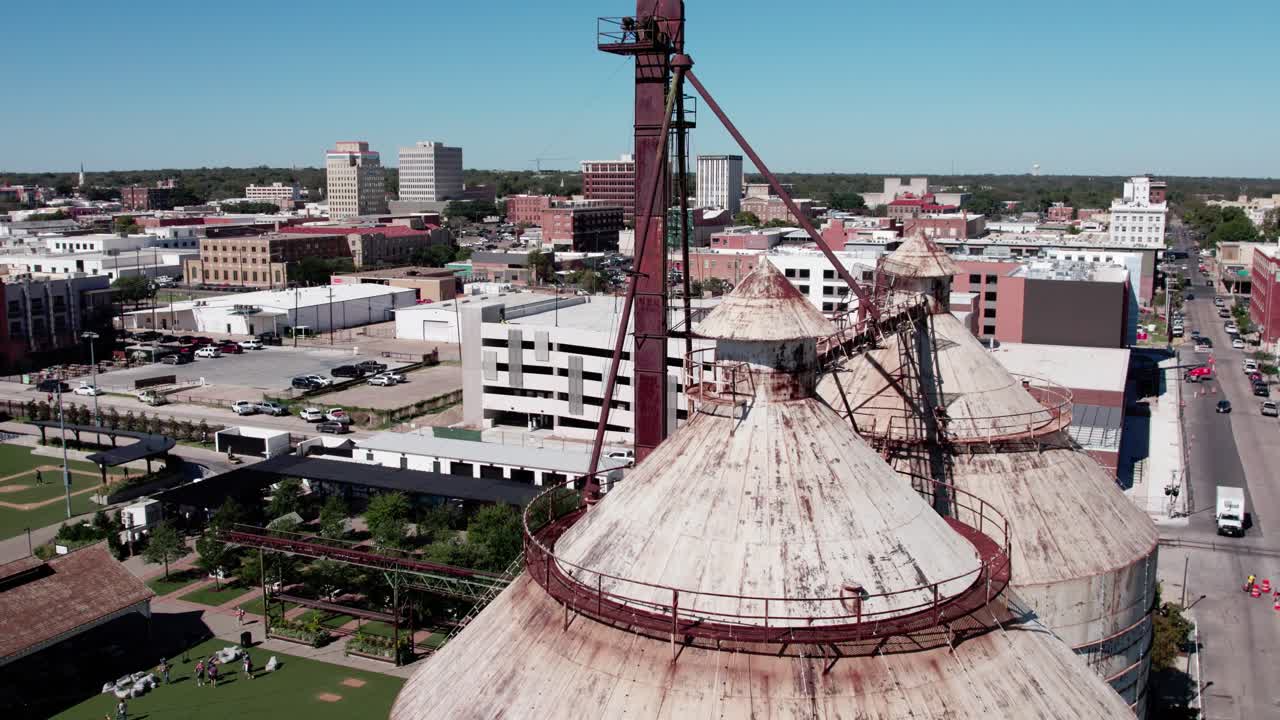 4K close-up drone footage of the silos in downtown Waco, showcasing the landmark's structure and surrounding architecture with smooth cinematic motion
