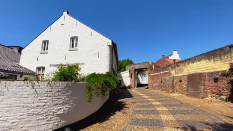 Typical-white-village-house-next-to-historic-monastery-in-Thorn-Limburg