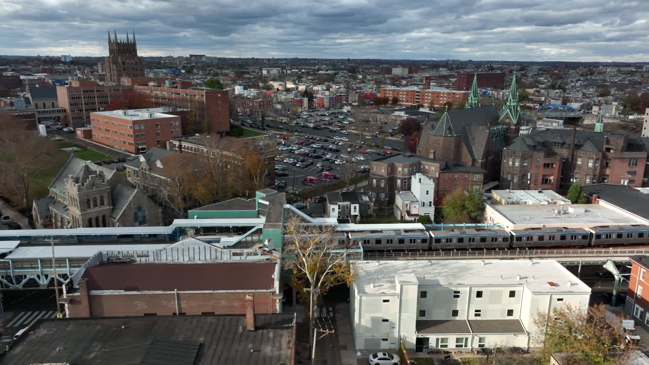 Aerial of SEPTA train in Kensington North Philly, elevated rail track in urban city.