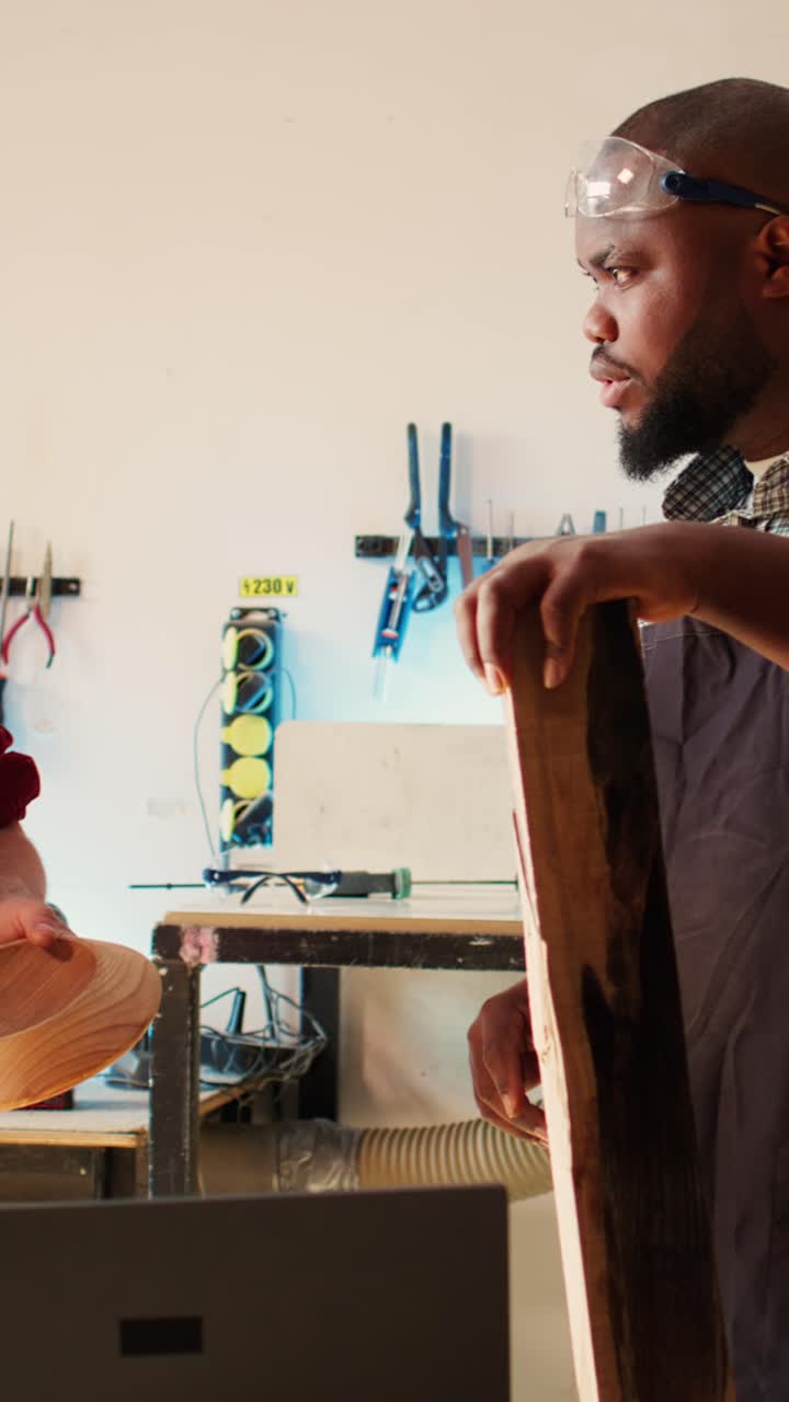 Two Woodworkers Discussing Wooden Craftsmanship in a Workshop