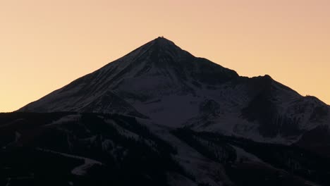 cinematic drone shot of lone mountain peak at sunset in montana