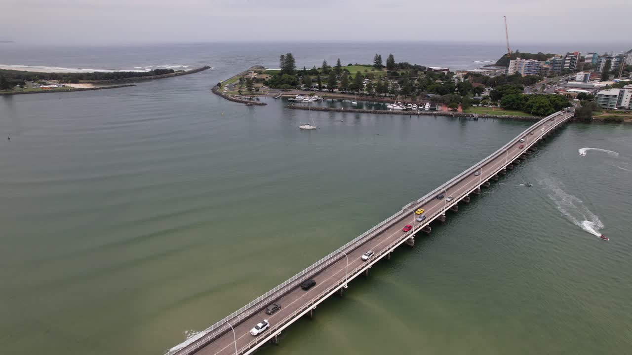 Vehicles Driving On Head Street Bridge Over Coolongolook River With Boats Cruising. Forster, New South Wales, Australia. aerial static shot