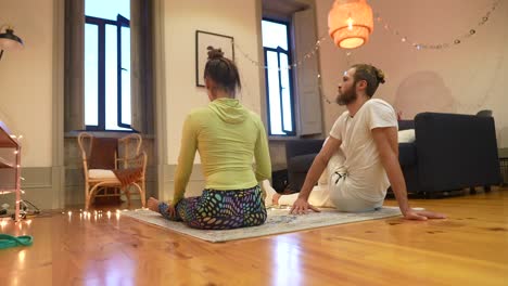 couple practicing yoga at home