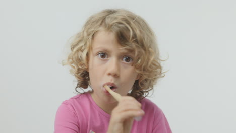 small girl brushing her teeth