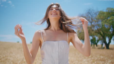 happy lady shake hair at summer meadow closeup. carefree woman sunshine portrait