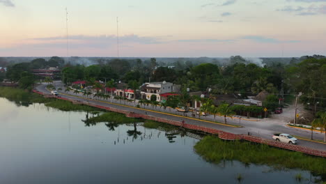 aerial landscape of lake beside road near coba town at golden hour sunset in mexico