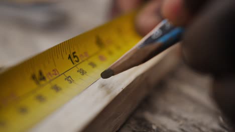 slow motion close up of carpenter measuring wood panel