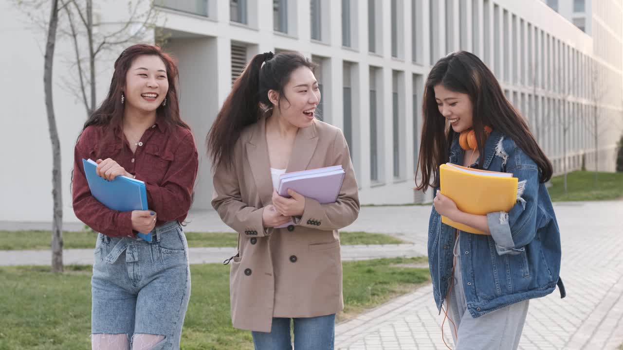 Group of female friends taking a selfie together with a mobile phone. Friendship concept. Students on campus