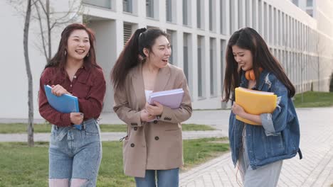 group of female friends taking a selfie together with a mobile phone. friendship concept. students on campus