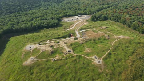 the fort of douaumont seen from above in the middle of the countryside and green forests towards verdun, in the meuse, in lorraine in the great east of france, in summer and by drone.