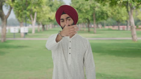 angry sikh indian man stopping someone in park