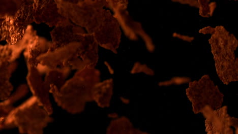 bran flakes bouncing against black background