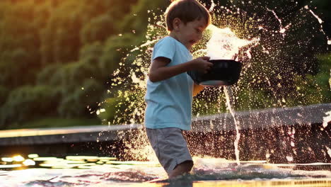 boy playing in water at sunset